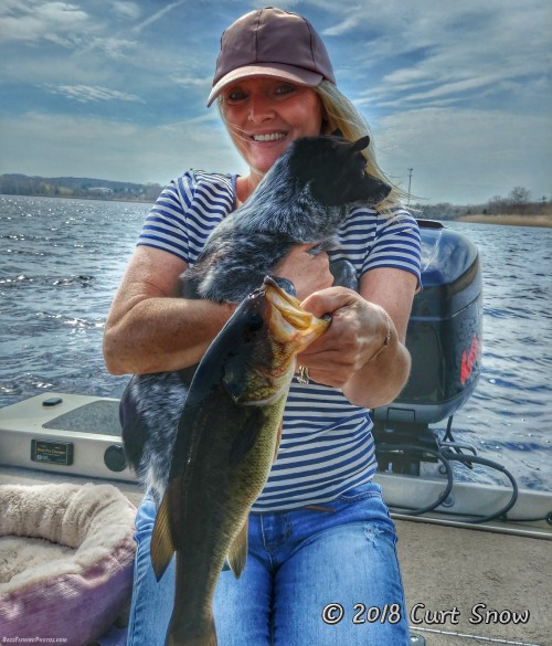 Catching bass even with a dog on her lap!